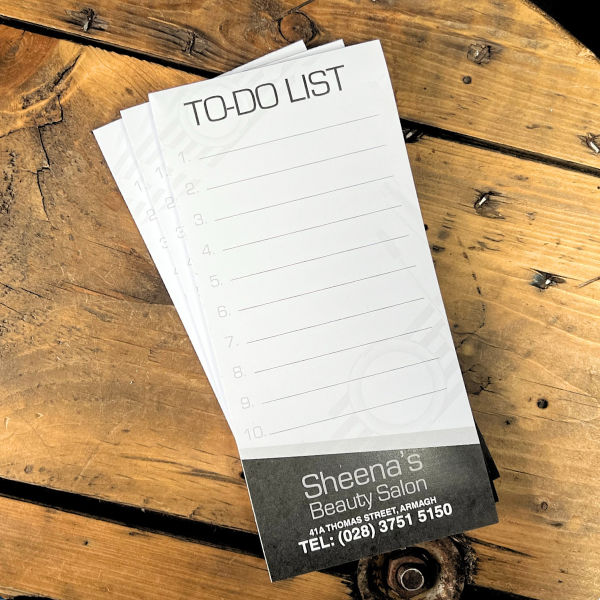 DL size notepads on wooden table